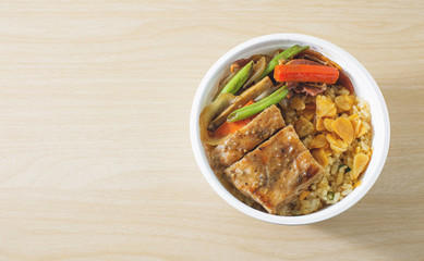 fried garlic rice with pork on wood background