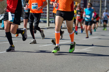 Marathon running race, runners feet on road, sport, fitness and healthy lifestyle concept
