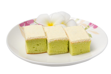 Square cake with cream in dish on white background