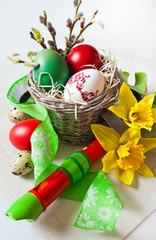 Traditional Czech easter decoration - my handmade painted eggs with daffodils flower, quail eggs, green ribbon and wooden music instrument flute. Spring easter holiday arrangement.