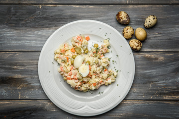 Traditional Russian salad Olivier with quail eggs. The view from the top