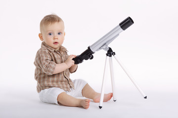 little boy with telescope exploring stars