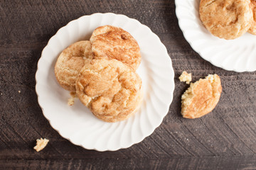 Two plates of Crumbled Snickerdoodle Cookies on a dark wooden background top view