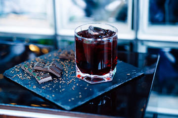 Glass of cherry juice with chocolate pieces