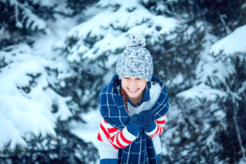 Fototapeta na wymiar winter outdoor portrait of a cute funny positive young girl