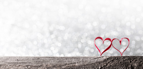 Two ribbon hearts on wood
