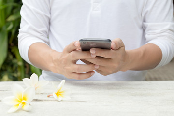 Young man using black smartphone