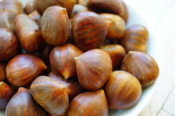 Bowl of fresh Italian chestnuts in the shell in winter