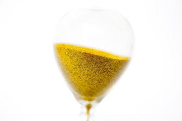 hourglass with gold beads on white background