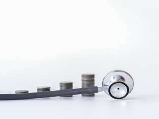 Stethoscope and coin stack on white background. money for health care, Financial Aid, concept.