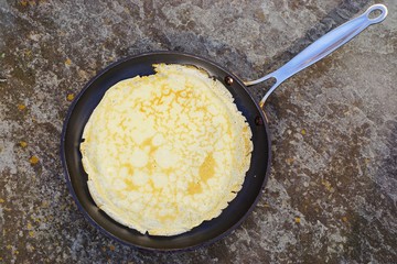 A French crepe just cooked in a flat pan