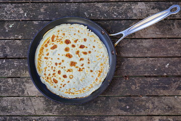 A French crepe just cooked in a flat pan