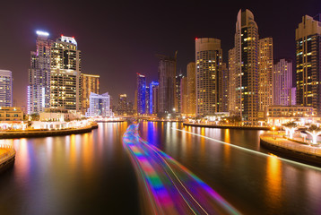 Fototapeta na wymiar Busy promenade and the bay in Dubai Marina in the evening,Dubai,United Arab Emirates