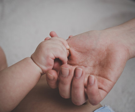 Closeup of a baby hand in hand mother