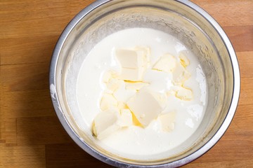 the dough in a bowl with the butter