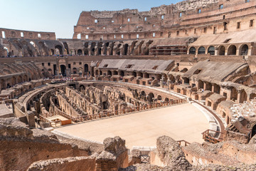 Fototapeta na wymiar Colosseum during daytime. People near old ruins. Tourists visiting famous landmark.