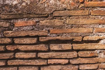 Ancient wall texture. Thin bricks and cement. Architecture of old world.