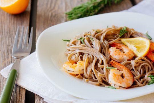 Soba noodles with roasted shrimps on dish