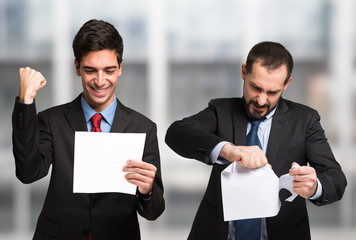 One businessman is happy of his contract, the other is not
