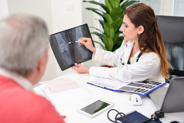 Doctor showing a radiography to a patient