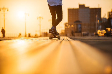Young man riding longboard on the bordwalk, feet only © sata_production