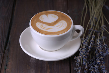 Coffee with a lavender on wooden table