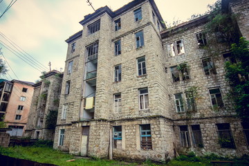 Fototapeta na wymiar Abandoned mining ghost-town Jantuha, Abkhazia. Destroyed empty houses 
