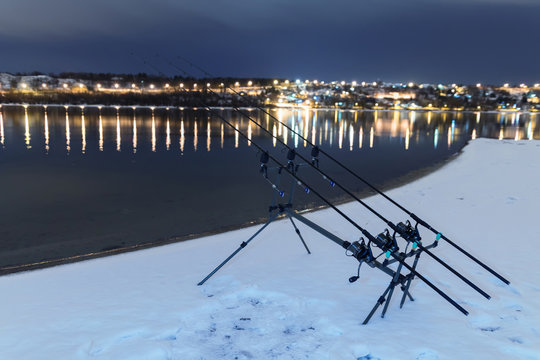 Carp spinning reel angling rods in winter night. Night Fishing