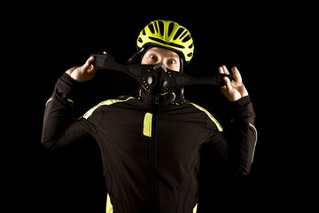 Portrait of young cyclist fully equipped for race in helmet and