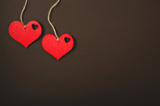 red hearts on a rope on a black background