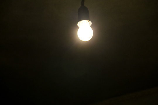 Electric light bulb on dark background