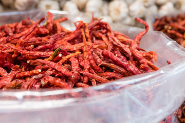 pile of dried red chili pepper in white plastic bag