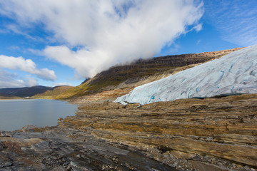 Ice front of Svartisen Glacier in Norway with lake