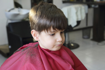 haircut of small boy in barbershop