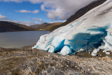 Ice front of Svartisen Glacier in Norway with lake