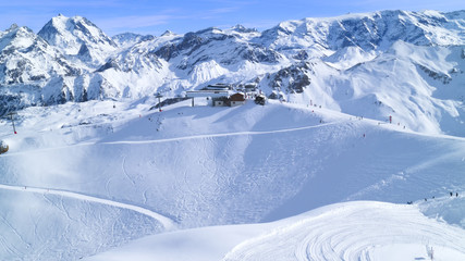 Fototapeta na wymiar Top view from alpine peaks on a chairlift, slopes near Courchevel winter resort, 3 Valleys, Alps, France