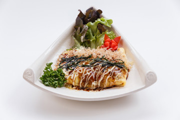 Japanese Omelette with Okonomiyaki Sauce Topping with Katsuobushi (dried, fermented, and smoked skipjack tuna), Seaweed and Mayonaise.