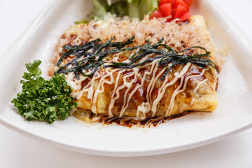 Japanese Omelette with Okonomiyaki Sauce Topping with Katsuobushi (dried, fermented, and smoked skipjack tuna), Seaweed and Mayonaise.
