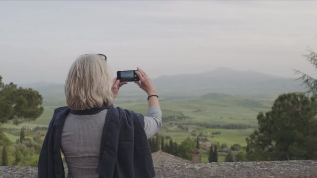 Senior woman taking photo with smart phone