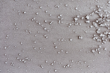 Fototapeta na wymiar Frosty pattern of frozen snow on the surface