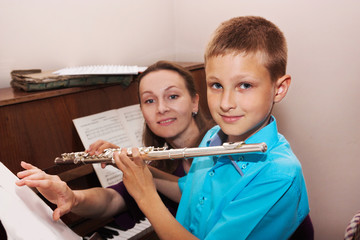Teacher and boy in a music school