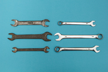 Rusty vintage wrenches isolated on a blue background