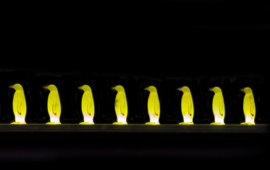 Night view of modern art installation of yellow penguins  in Prague, Czech Republic