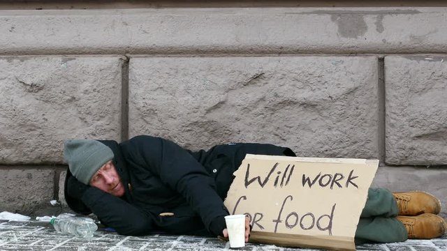 
4K.  city winter  street and homeless  unemployment adult man .
