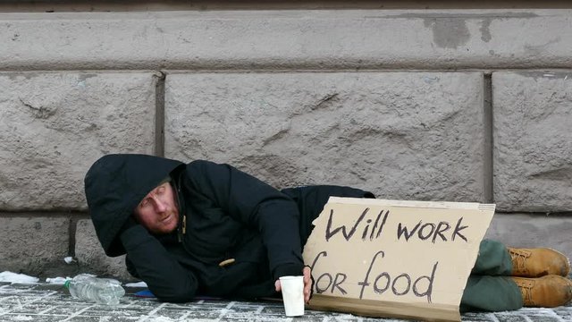 
4K.  city winter  street and homeless  unemployment adult man have handout .
