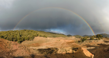 Rainbow and dark clouds, Ifrane National Park, Morocco 