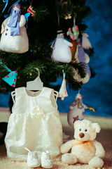 The small dress for baby hangs on the branch