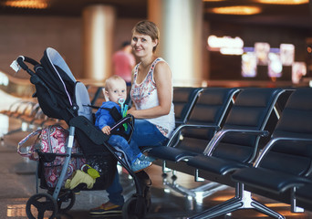 Mom and infant communicate while waiting for his flight