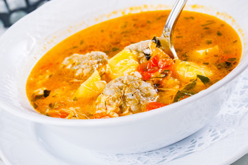 Traditional armenian soup kololik. Tomato soup with meatballs and rice