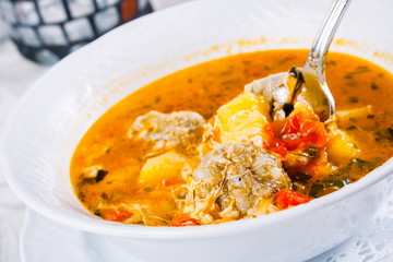 Traditional armenian soup kololik. Tomato soup with meatballs and rice